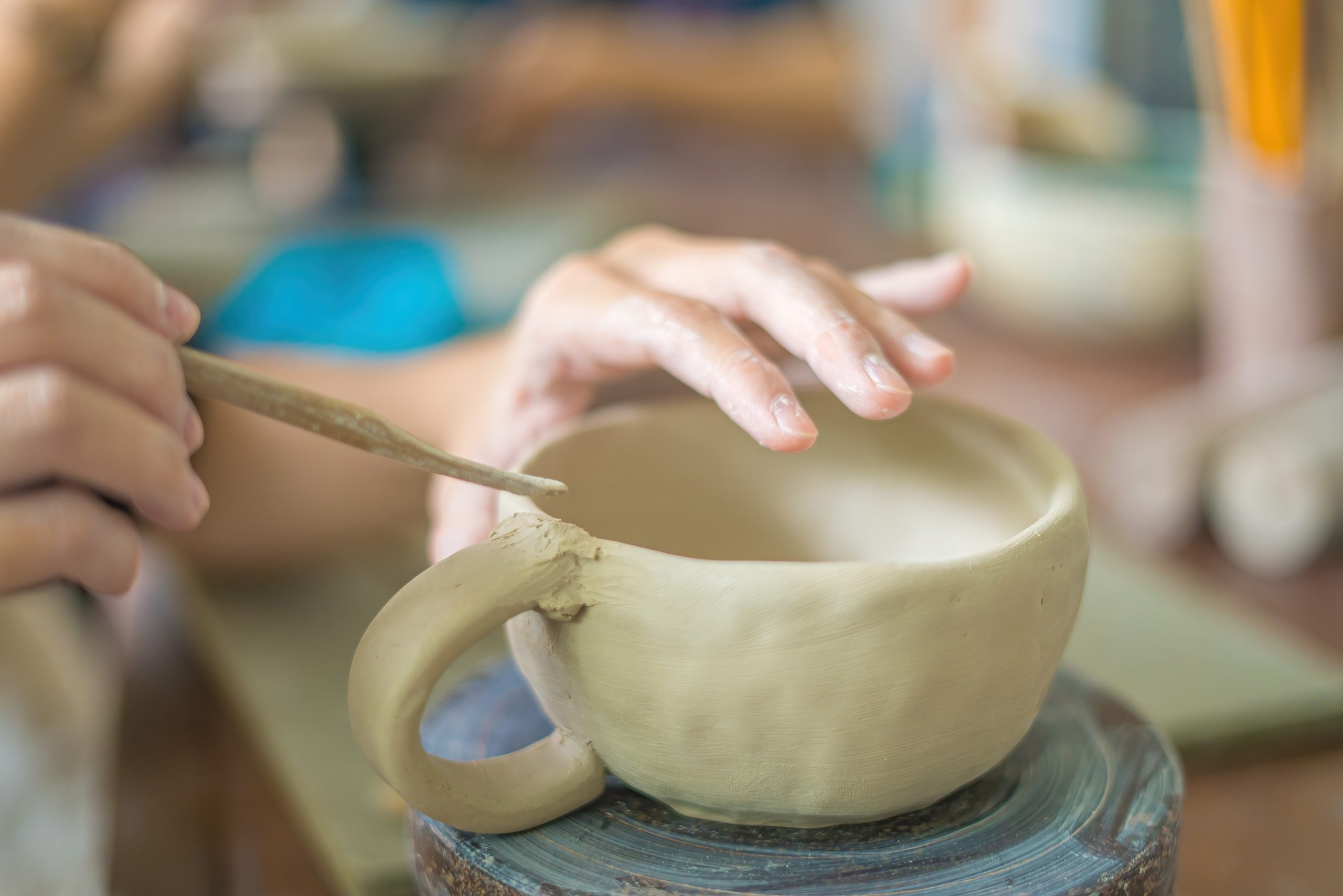 Woman,Potter,Working,On,Potters,Wheel,Making,Ceramic,Pot,From