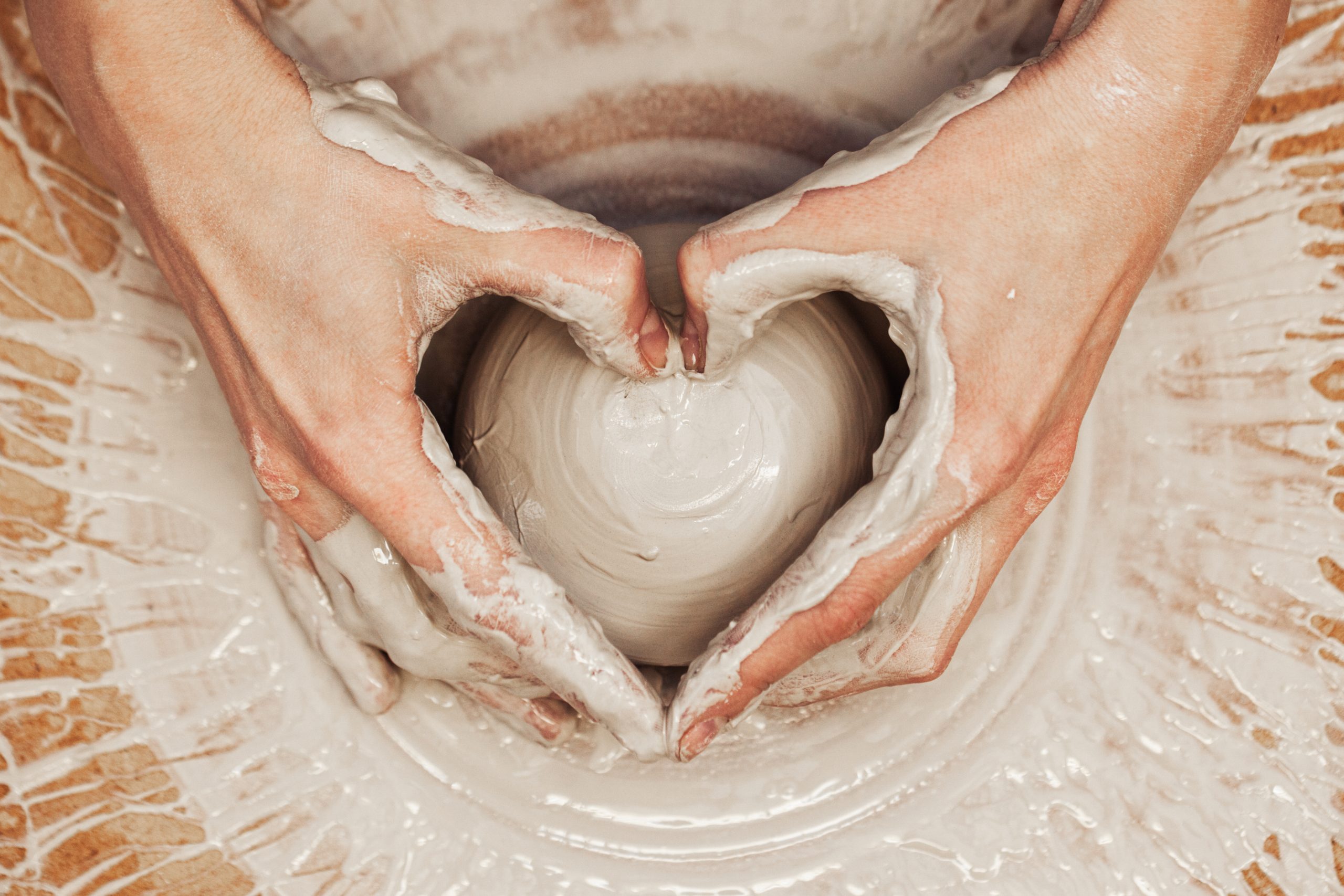 Woman,Working,On,The,Potter's,Wheel.,Artisan,Making,A,Cup