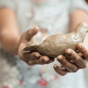 Blurry,Little,Girl,Showing,Her,Art,Work,(a,Bird,dove,)